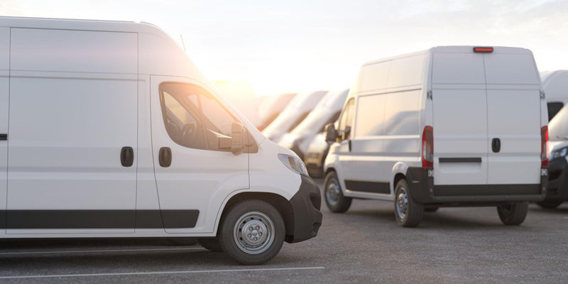 Delivery vans in a row in the rays of sunset or dawn