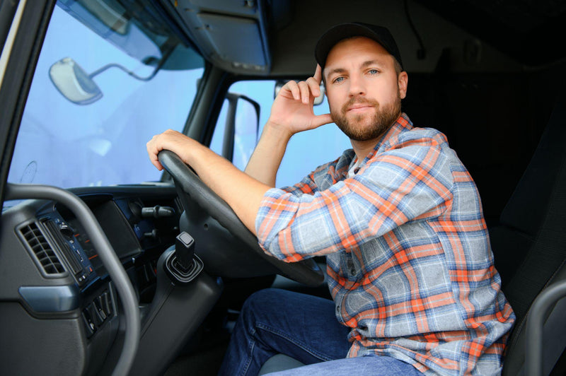 driver behind the wheel in truck cabin