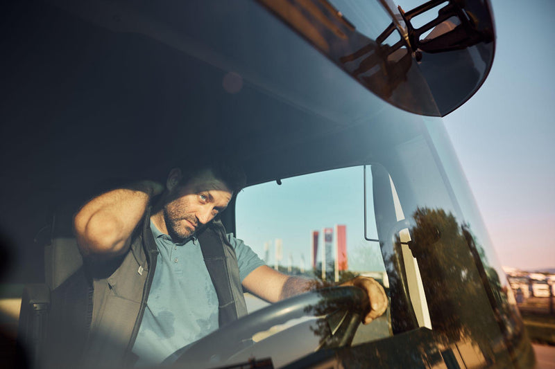 Truck driver having neck pain during long ride on the road.