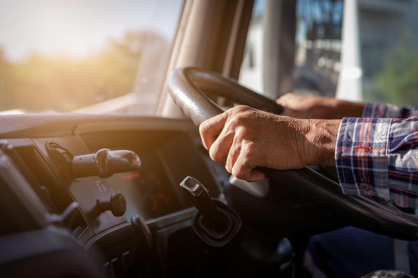 Truck driver keeps driving with one hands and change gears