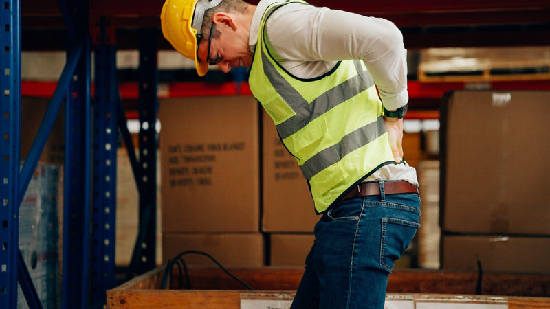 warehouse worker having back pain at work