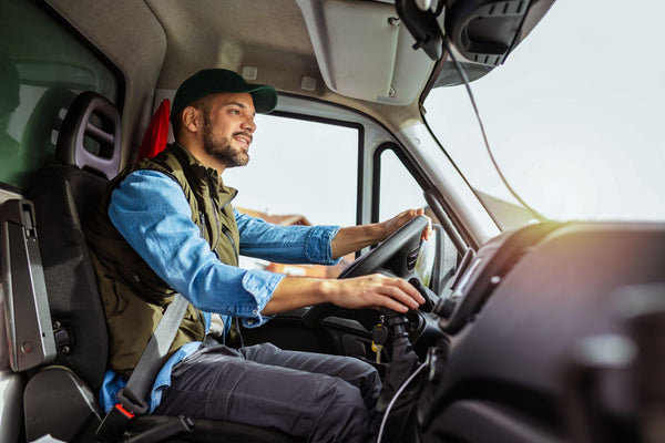 Young handsome man working in towing service and driving his truck.